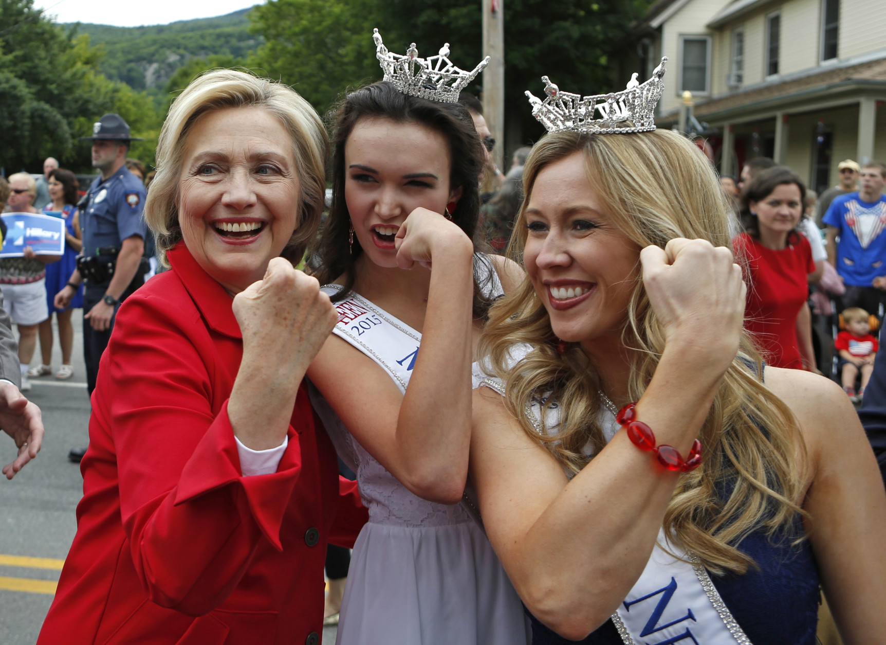 FOR USE AS DESIRED, YEAR END PHOTOS - FILE - Democratic presidential candidate Hillary Rodham Clinton flexes her muscles with Miss Teen New Hampshire Allie Knault, center, and Miss New Hampshire Holly Blanchard, during a Fourth of July parade, Saturday, July 4, 2015, in Gorham, N.H. (AP Photo/Robert F. Bukaty, File)