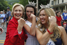 FOR USE AS DESIRED, YEAR END PHOTOS - FILE - Democratic presidential candidate Hillary Rodham Clinton flexes her muscles with Miss Teen New Hampshire Allie Knault, center, and Miss New Hampshire Holly Blanchard, during a Fourth of July parade, Saturday, July 4, 2015, in Gorham, N.H. (AP Photo/Robert F. Bukaty, File)