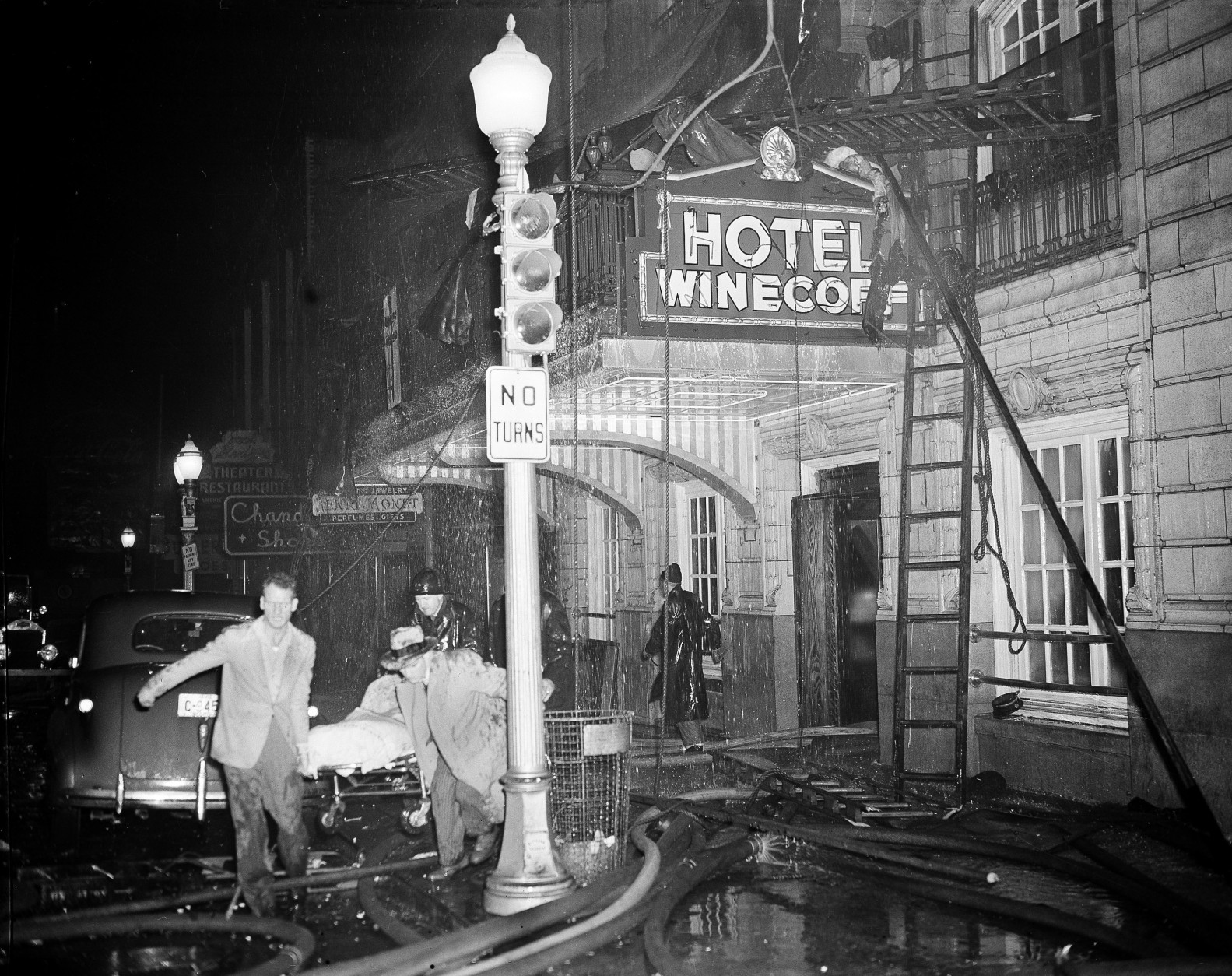 Rescue workers carry an unidentified victim from the still-blazing Winecoff Hotel in Atlanta, Ga., Dec. 7, 1946.  Officials estimate that over a hundred may be dead.  (AP Photo)