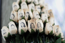 FILE - In this Jan. 14, 2013 file photo, white roses with the faces of victims of the Sandy Hook Elementary School shooting are attached to a telephone pole near the school on the one-month anniversary of the shooting that left 26 dead in Newtown, Conn. The second anniversary of the shooting is Sunday, Dec. 14, 2014 and the town is not holding any public commemoration ceremonies. First Selectman Pat Llodra and school Superintendent Joseph Erardi said the day will be marked through personal reflection and remembrance. (AP Photo/Jessica Hill, File)