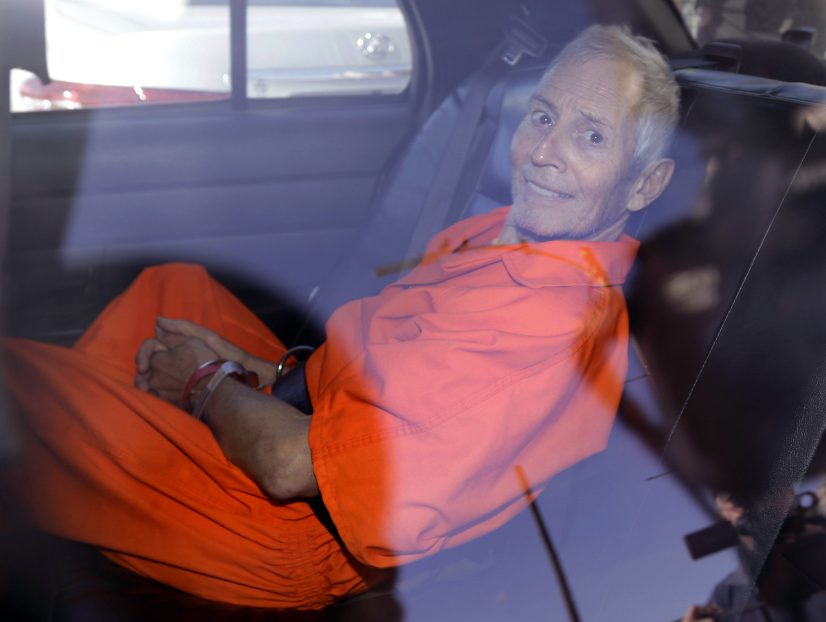 FOR USE AS DESIRED, YEAR END PHOTOS - FILE - Robert Durst is transported from Orleans Parish Criminal District Court to the Orleans Parish Prison after his arraignment on murder charges in New Orleans, Tuesday, March 17, 2015. (AP Photo/Gerald Herbert, File)