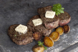 This July 28, 2014, photo shows buttered black pepper bison steaks in Concord, N.H. The widely available alternative to beef is naturally lean and deeply flavorful. (AP Photo/Matthew Mead)