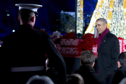 President Barack Obama looks to a member of the military as he walks to his seat during the  National Christmas Tree Lighting ceremony at the Ellipse in Washington, Thursday, Dec. 3, 2015. (AP Photo/Carolyn Kaster)