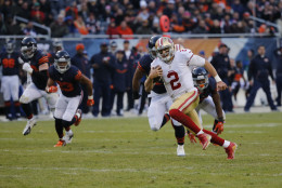 San Francisco 49ers quarterback Blaine Gabbert (2) runs to the end zone for a touchdown during the second half of an NFL football game against the Chicago Bears, Sunday, Dec. 6, 2015, in Chicago. (AP Photo/Charles Rex Arbogast)