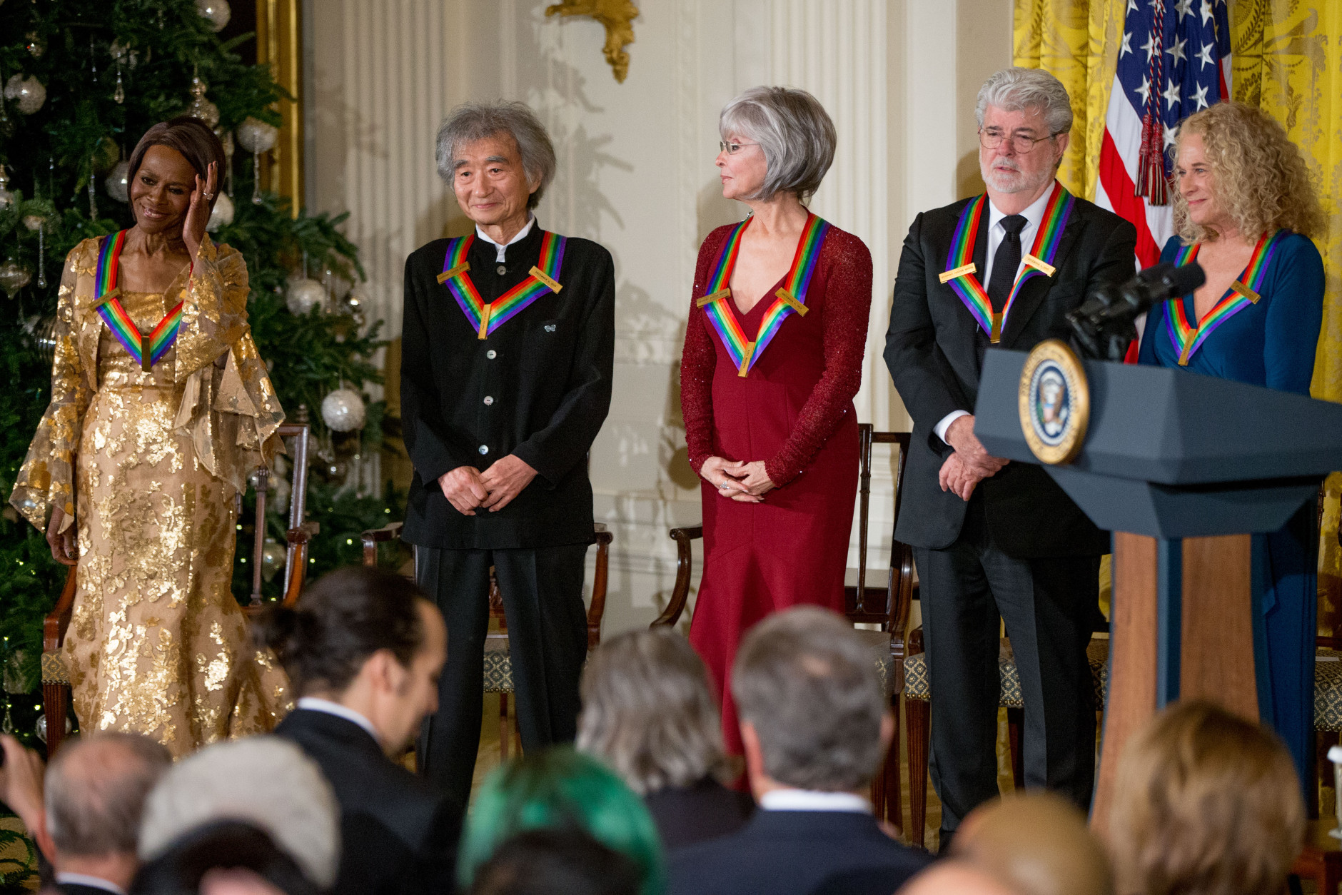 The 2015 Kennedy Center Honors Honorees, from left, actress Cicely Tyson, conductor Seiji Ozawa, actress and singer Rita Moreno, filmmaker George Lucas, and singer-songwriter Carole King stand on stage during a reception for them in the East Room of the White House, Sunday, Dec. 6, 2015, in Washington. (AP Photo/Andrew Harnik)
