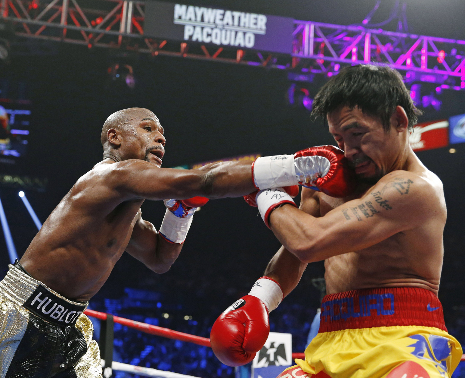 Floyd Mayweather Jr., left, connects with a right to the head of Manny Pacquiao, from the Philippines, during their welterweight title fight on Saturday, May 2, 2015 in Las Vegas. (AP Photo/John Locher, File)