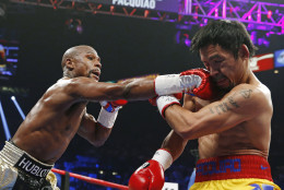 Floyd Mayweather Jr., left, connects with a right to the head of Manny Pacquiao, from the Philippines, during their welterweight title fight on Saturday, May 2, 2015 in Las Vegas. (AP Photo/John Locher, File)