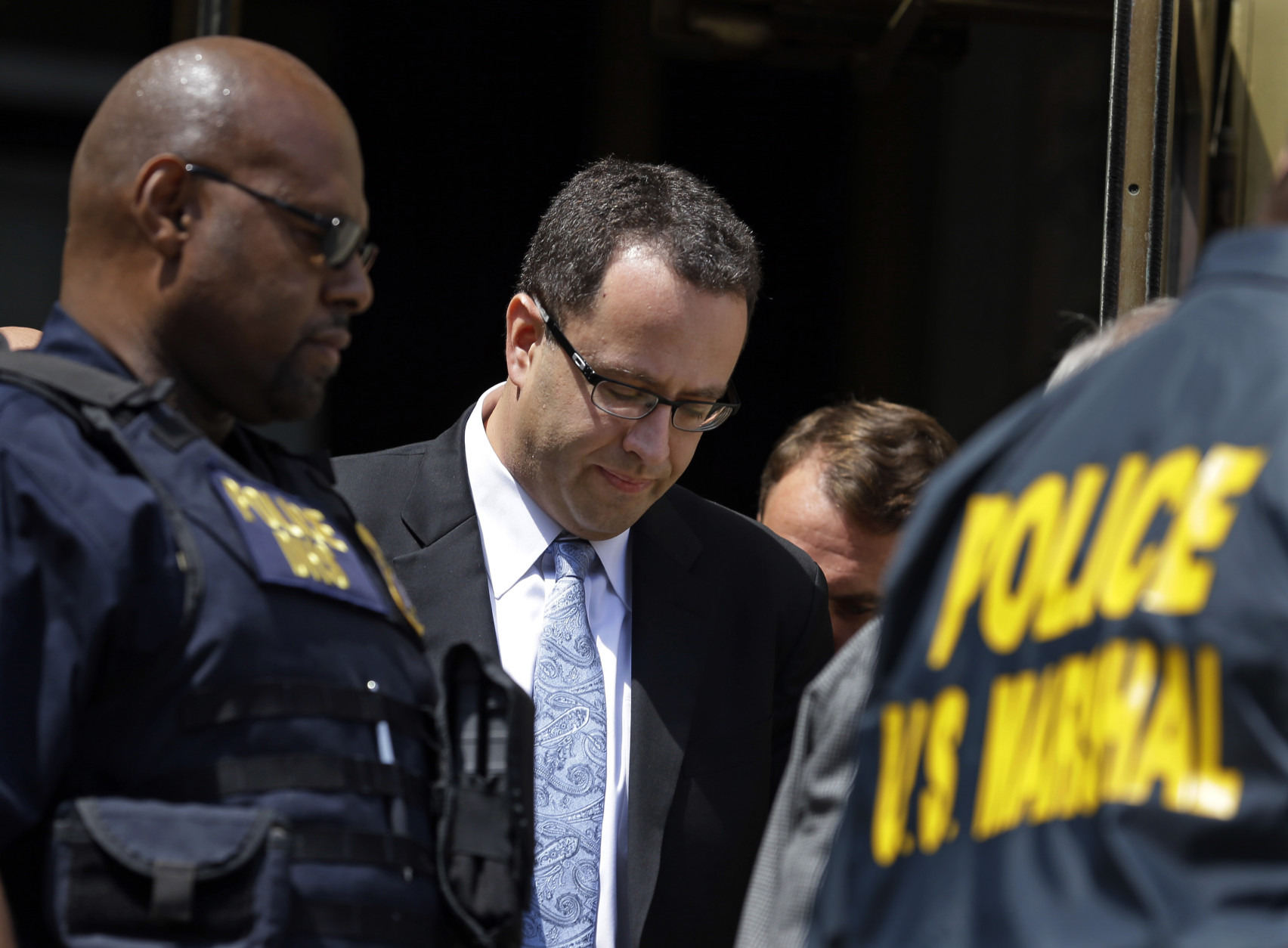 FOR USE AS DESIRED, YEAR END PHOTOS - FILE - Former Subway pitchman Jared Fogle leaves the Federal Courthouse in Indianapolis, Wednesday, Aug. 19, 2015, following a hearing on child-pornography charges. Fogle agreed to plead guilty to allegations that he paid for sex acts with minors and received child pornography in a case that destroyed his career at the sandwich-shop chain and could send him to prison for more than a decade.  (AP Photo/Michael Conroy, File)