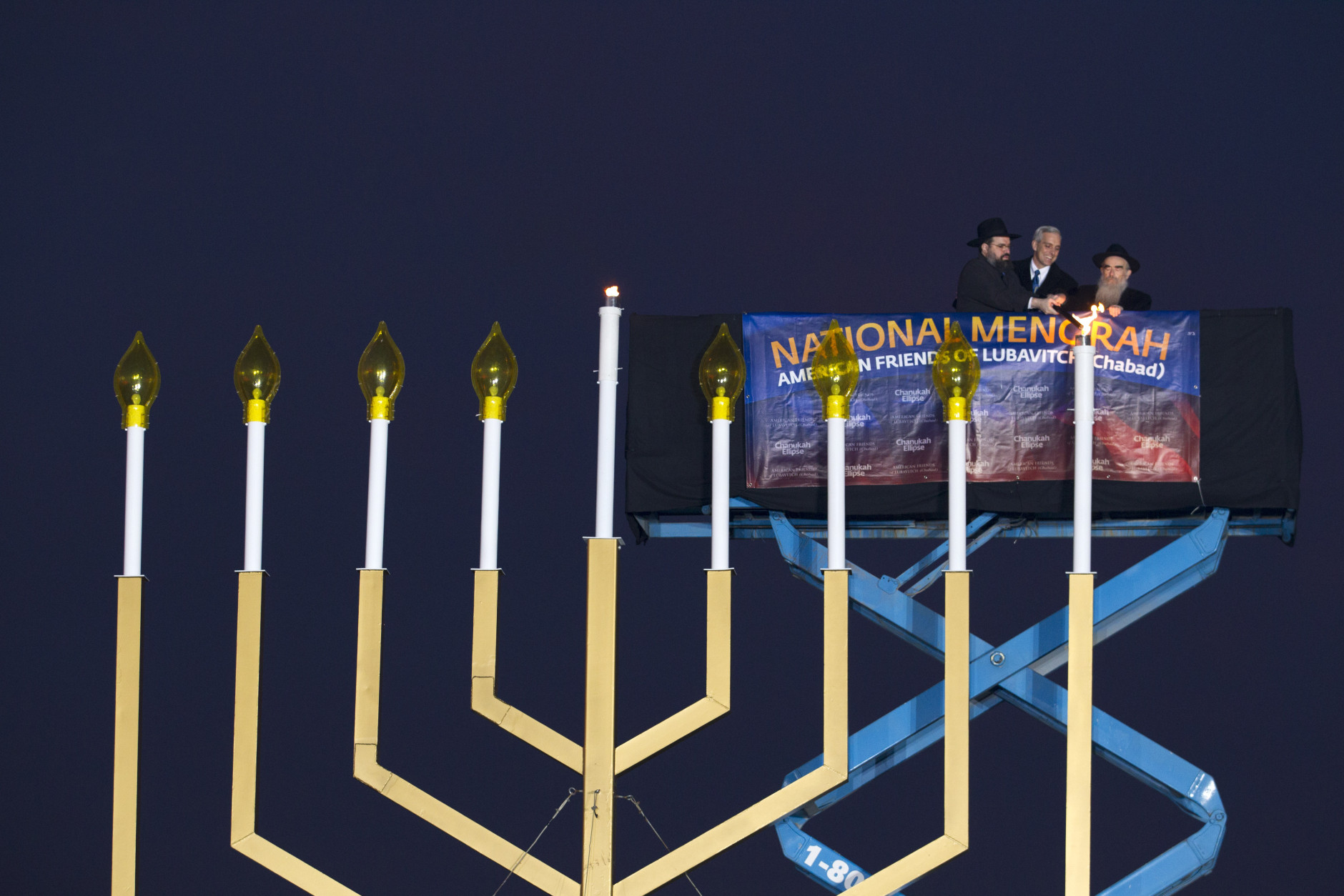 From left, Rabbi Levi Shemtov, White House Chief of Staff Denis McDonough and Rabbi Abraham Shemtov participate in the annual National Menorah Lighting in celebration of Hanukkah, on the Ellipse near the White House in Washington, Sunday, Dec. 6, 2015. (AP Photo/Jose Luis Magana)