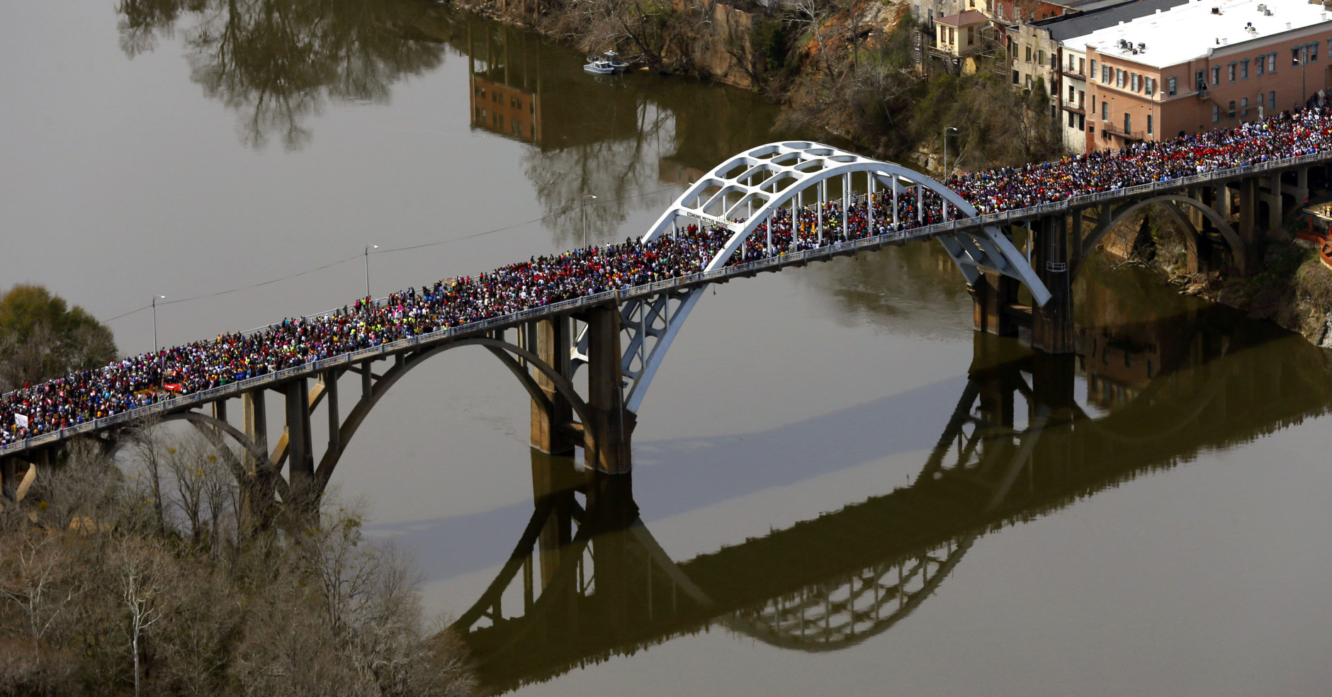 FOR USE AS DESIRED, YEAR END PHOTOS - FILE - A large crowd moves in a symbolic walk across the Edmund Pettus Bridge, Sunday, March 8, 2015, in Selma, Ala., to mark the 50th anniversary of "Bloody Sunday," a civil rights march in which protestors were beaten, trampled and tear-gassed by police at the bridge. (AP Photo/Butch Dill, File)