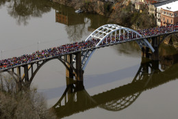 FOR USE AS DESIRED, YEAR END PHOTOS - FILE - A large crowd moves in a symbolic walk across the Edmund Pettus Bridge, Sunday, March 8, 2015, in Selma, Ala., to mark the 50th anniversary of "Bloody Sunday," a civil rights march in which protestors were beaten, trampled and tear-gassed by police at the bridge. (AP Photo/Butch Dill, File)