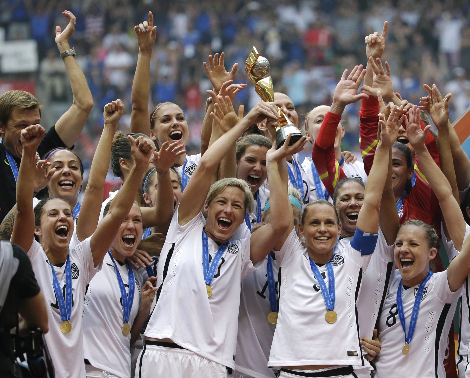 FOR USE AS DESIRED, YEAR END PHOTOS - FILE - The United States Women's National Team celebrates with the trophy after they beat Japan 5-2 in the FIFA Women's World Cup soccer championship in Vancouver, British Columbia, Canada, Sunday, July 5, 2015. (AP Photo/Elaine Thompson, File)