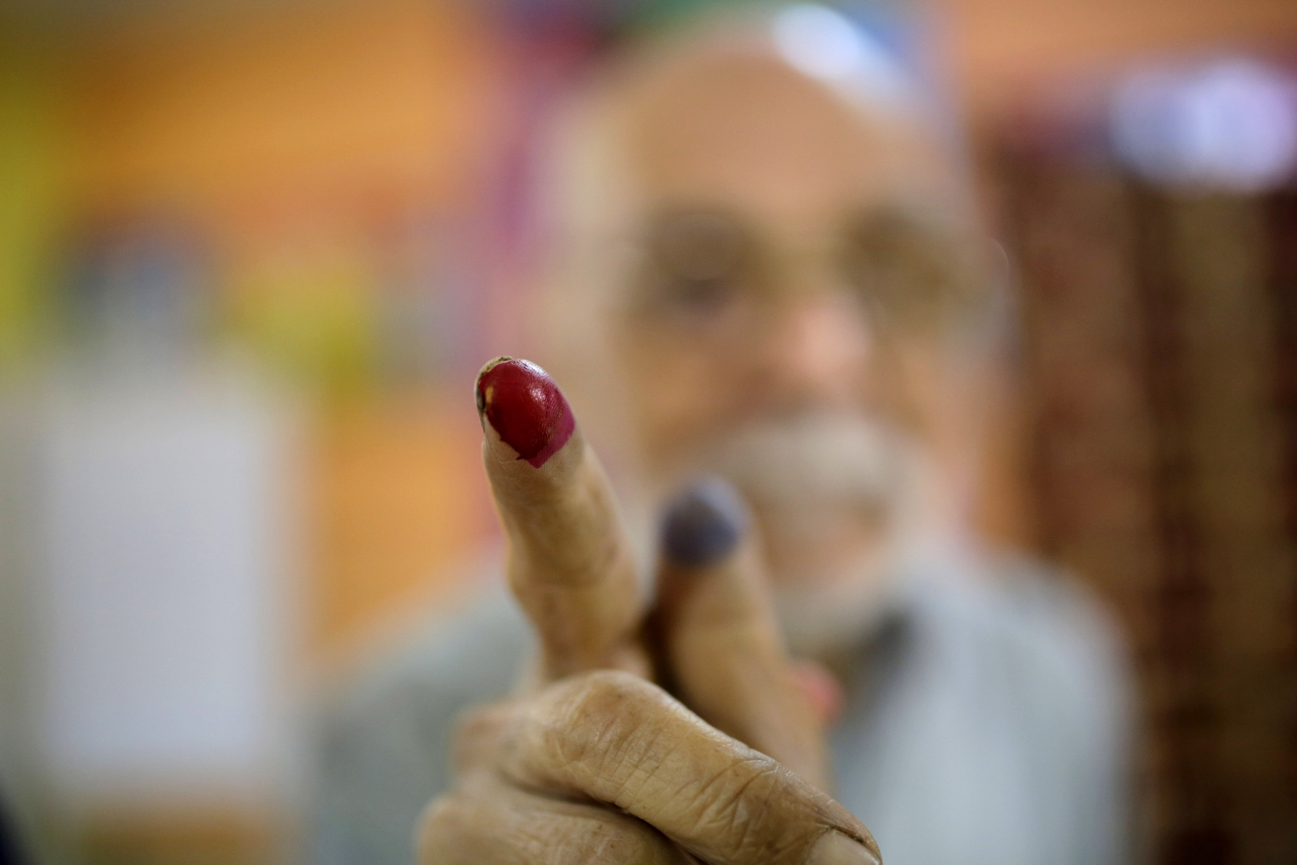 FOR USE AS DESIRED, YEAR END PHOTOS - FILE - Egyptian voter Abdel Moneam Kandil, 80, shows his inked finger after he voted at a polling station for the runoff to the first round of the parliamentary elections in Giza, just outside of Cairo, Egypt, Wednesday, Oct. 28, 2015. (AP Photo/Amr Nabil, File)