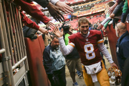 Washington Redskins quarterback Kirk Cousins (8) is greeted by fans as he leaves the field after an NFL football game against the Buffalo Bills in Landover, Md., Sunday, Dec. 20, 2015. The Washington Redskins defeated the Buffalo Bills 35-25. (AP Photo/Jacquelyn Martin)