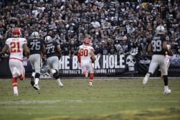 Kansas City Chiefs inside linebacker Josh Mauga (90) runs with an interception in front of Oakland Raiders tackle J'Marcus Webb (76) and tackle Austin Howard (77) during the second half of an NFL football game in Oakland, Calif., Sunday, Dec. 6, 2015. (AP Photo/Marcio Jose Sanchez)