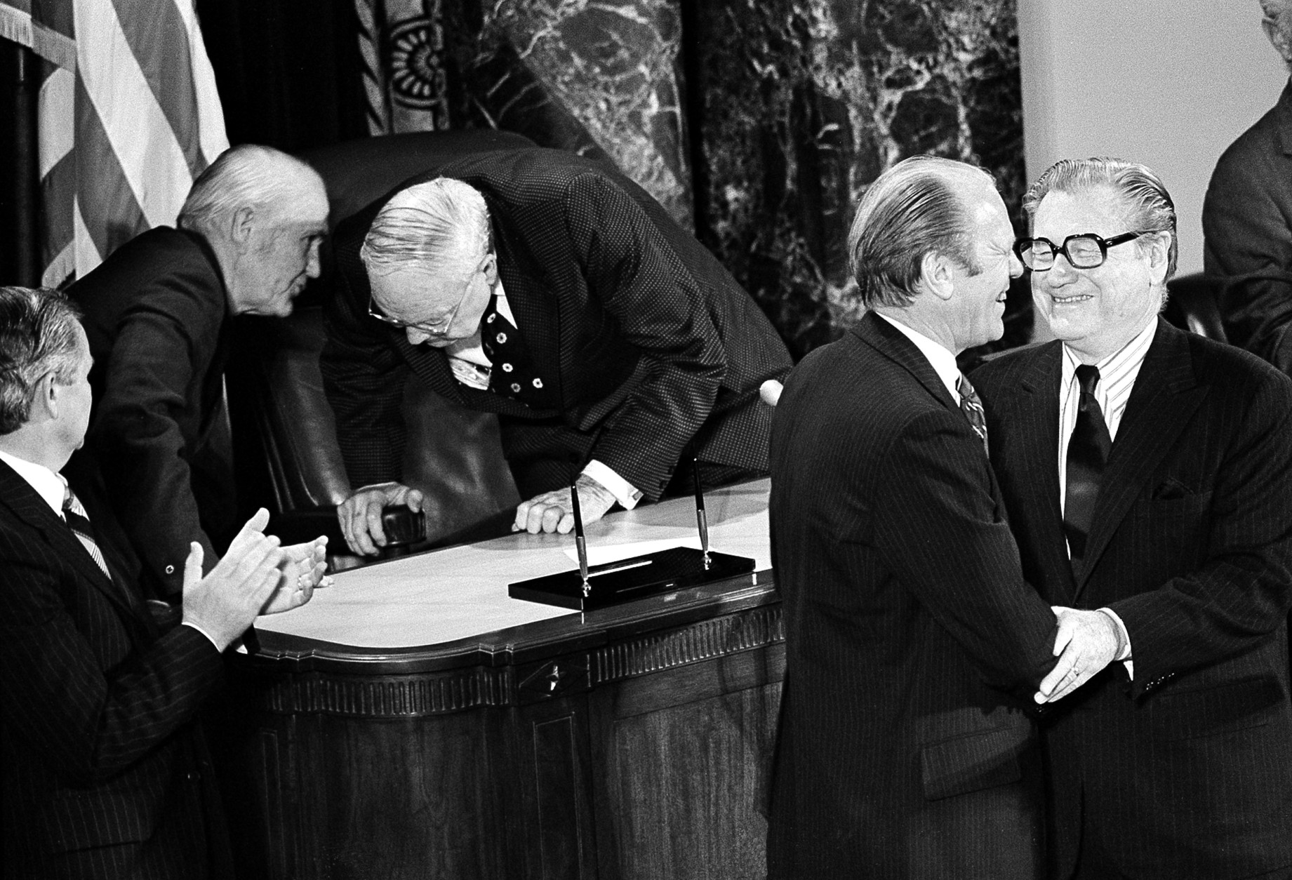U.S. President Gerald Ford congratulates Vice President Nelson A. Rockefeller, right, after he was sworn-in on the floor of the Senate in Washington, D.C., Thursday night, Dec. 19, 1974.  Rockefeller is the 41st vice president of the United States.  (AP Photo)