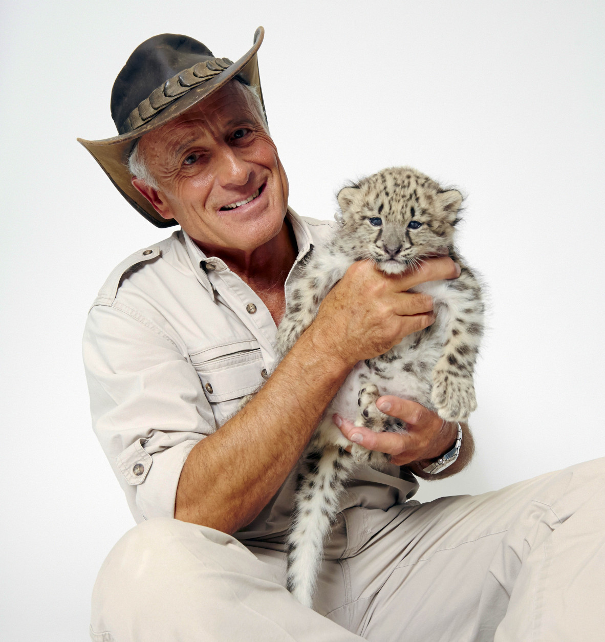 Wildlife advocate Jack Hanna poses for a portrait with a snow leopard cub on Monday, Oct. 12, 2015 in New York. (Photo by Dan Hallman/Invision/AP)