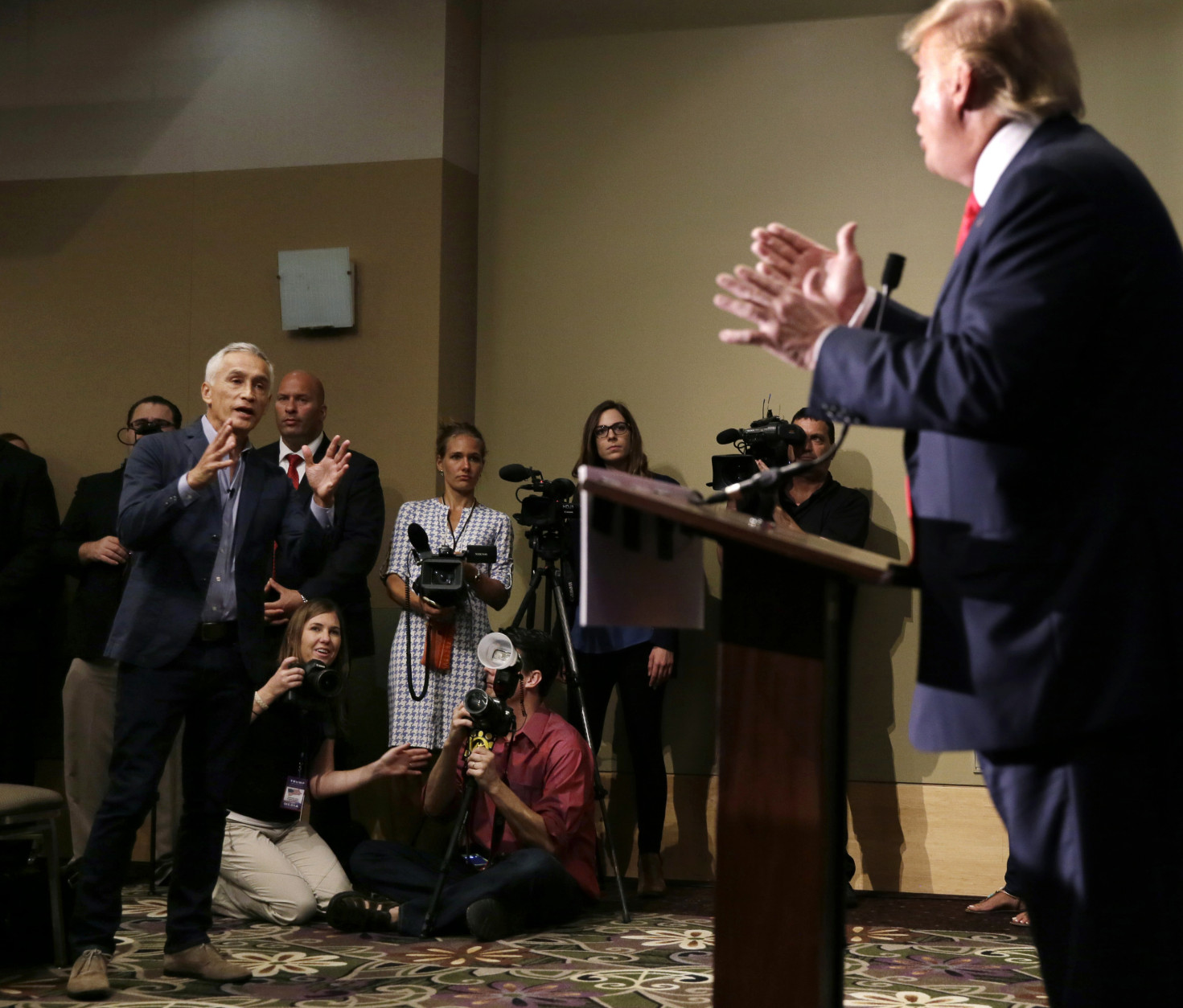 FOR USE AS DESIRED, YEAR END PHOTOS - FILE - Miami-based Univision anchor Jorge Ramos, left, asks Republican presidential candidate Donald Trump a question about his immigration proposal during a news conference, Tuesday, Aug. 25, 2015, in Dubuque, Iowa. Ramos was later removed from the room. (AP Photo/Charlie Neibergall, File)