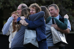 FOR USE AS DESIRED, YEAR END PHOTOS - FILE - Faculty members embrace as they are allowed to return to Umpqua Community College Monday, Oct. 5, 2015, in Roseburg, Ore. The campus reopened to faculty for the first time since Oct. 1, when armed suspect Chris Harper-Mercer killed multiple people and wounded several others before taking his own life at Snyder Hall. (AP Photo/John Locher, File)