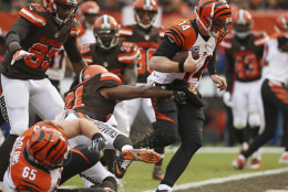 Cincinnati Bengals quarterback Andy Dalton (14) runs for a 3-yard touchdown in the first half of an NFL football game against the Cleveland Browns, Sunday, Dec. 6, 2015, in Cleveland. (AP Photo/Ron Schwane)