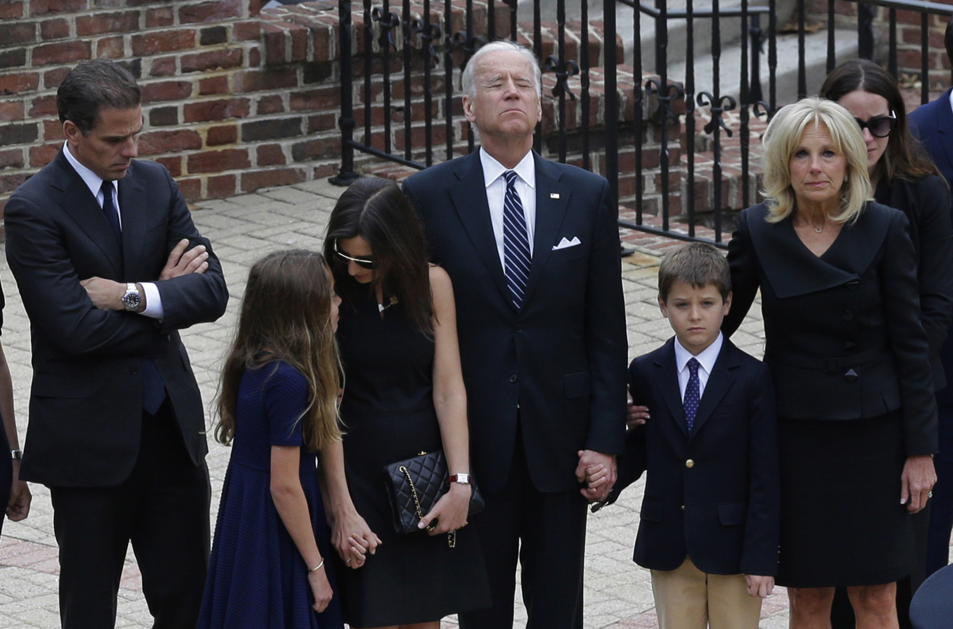 FOR USE AS DESIRED, YEAR END PHOTOS - FILE - Vice President Joe Biden, center, pauses alongside his family as they to enter a visitation for his son, former Delaware Attorney General Beau Biden, Thursday, June 4, 2015, at Legislative Hall in Dover, Del. Standing with Biden are his son Hunter, from left, granddaughter Natalie, daughter-in-law Hallie, grandson Hunter and wife Jill. Beau Biden died of brain cancer Saturday at age 46. (AP Photo/Patrick Semansky, Pool, File)