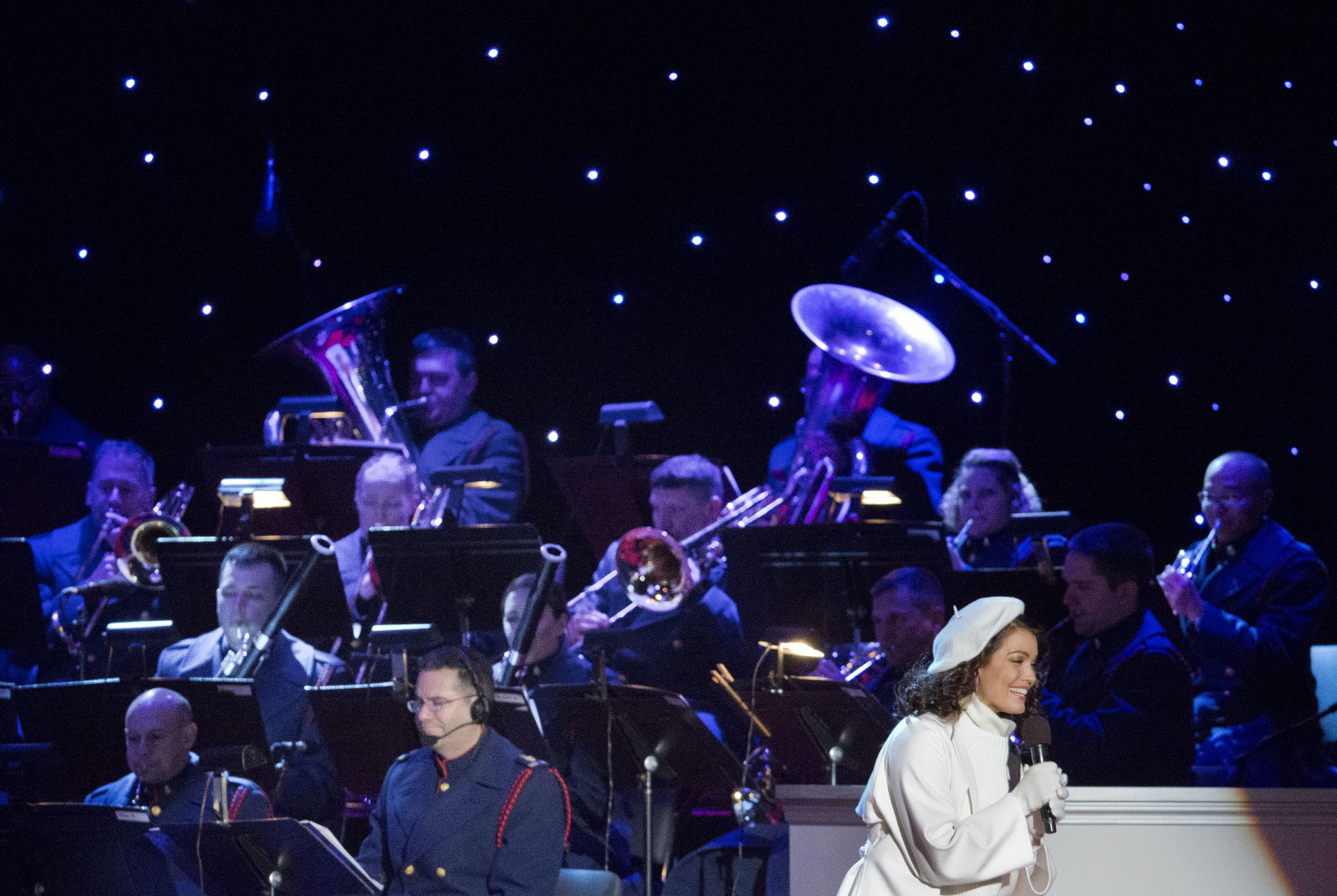 Actress Bellamy Young performs on stage with the United States Coast Guard Band during the National Christmas Tree Lighting ceremony at the Ellipse in Washington, Thursday, Dec. 3, 2015. (AP Photo/Pablo Martinez Monsivais)