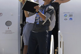 FOR USE AS DESIRED, YEAR END PHOTOS - FILE - Golden State Warriors guard Stephen Curry, foreground, yells as he carries the Larry O'Brien NBA championship trophy in front of center Andrew Bogut after the team's flight landed in Oakland, Calif., Wednesday, June 17, 2015. The Warriors defeated the Cleveland Cavaliers to win their first NBA championship since 1975. (AP Photo/Jeff Chiu, File)