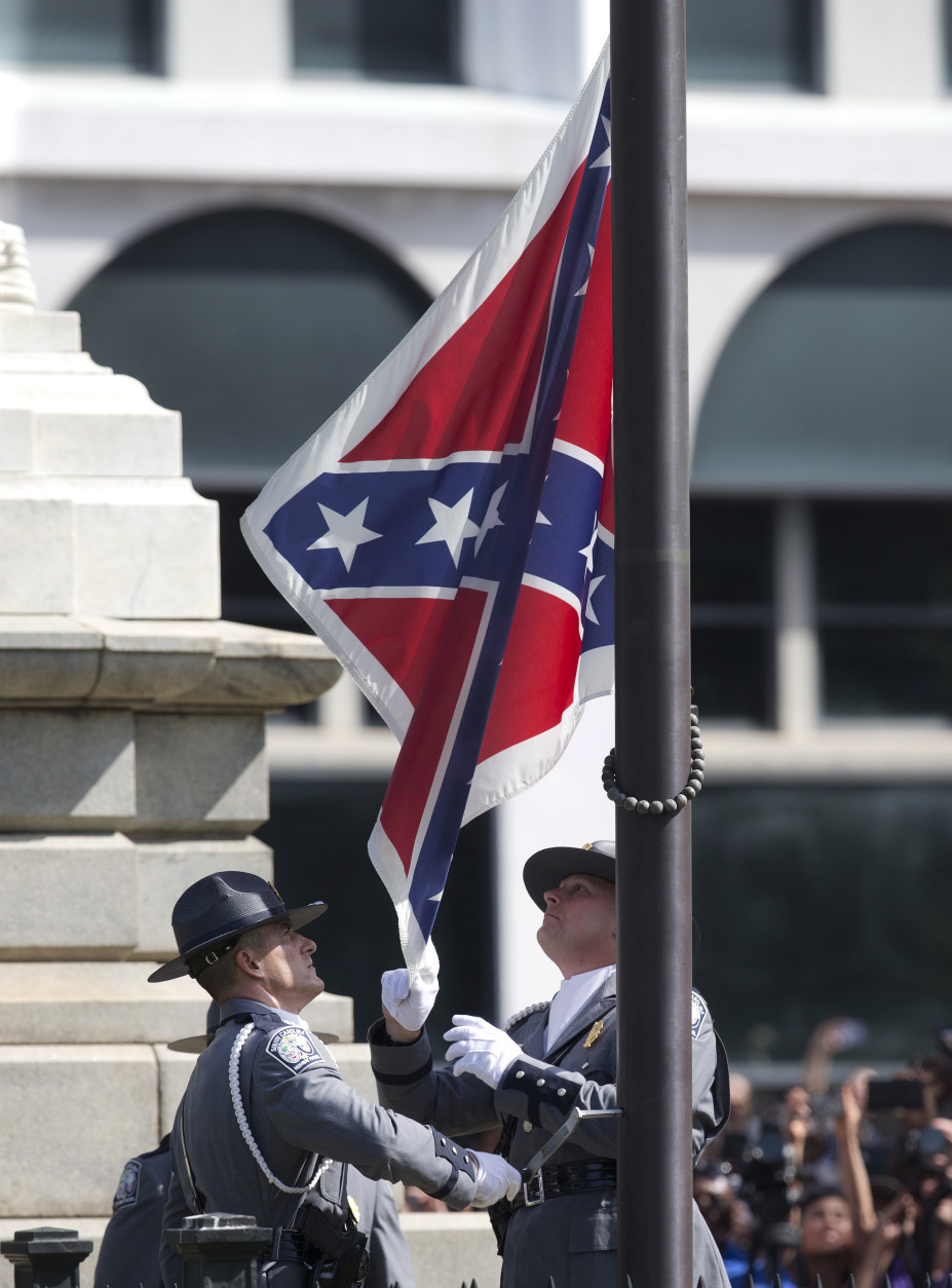 FOR USE AS DESIRED, YEAR END PHOTOS - FILE - An honor guard from the South Carolina Highway patrol removes the Confederate battle flag from the Capitol grounds in Columbia, S.C., ending its 54-year presence there, on Friday, July 10, 2015. (AP Photo/John Bazemore, File)