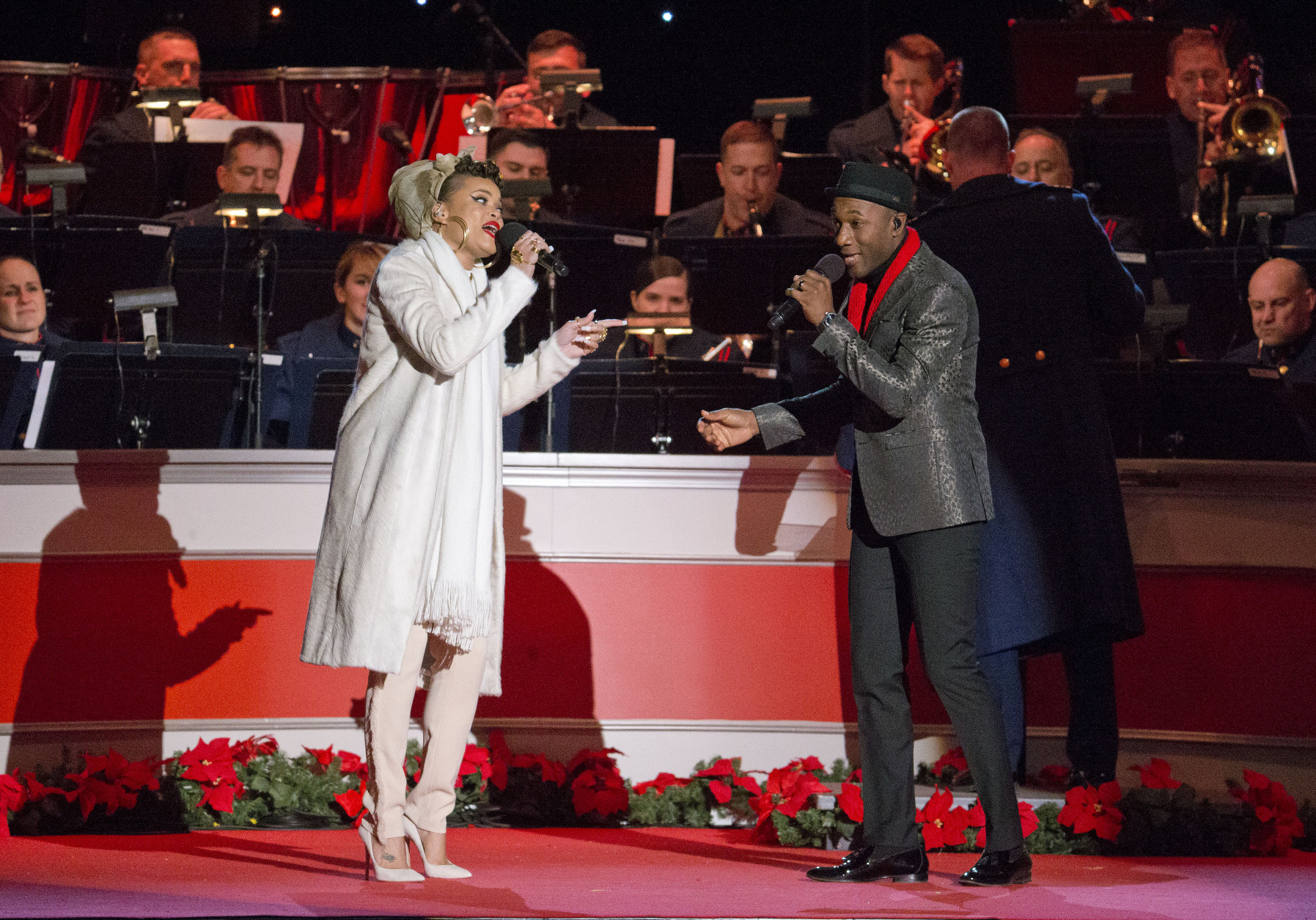 Singers Andra Day, left, and Aloe Blacc, right, perform onstage during the National Christmas Tree Lighting ceremony at the Ellipse in Washington, Thursday, Dec. 3, 2015. (AP Photo/Pablo Martinez Monsivais)