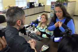 FOR USE AS DESIRED, YEAR END PHOTOS - FILE - Rowan County Clerk Kim Davis, right, talks with David Moore following her office's refusal to issue marriage licenses at the Rowan County Courthouse in Morehead, Ky., Tuesday, Sept. 1, 2015. Although her appeal to the U.S. Supreme Court was denied, Davis still refused to issue marriage licenses. (AP Photo/Timothy D. Easley, File)