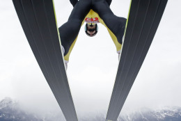 Switzerland's Gregor Deschwanden soars during the trial jump at the third stage of the four hills ski jumping tournament in Innsbruck, Austria, Sunday, Jan. 4, 2015. (AP Photo/Matthias Schrader)