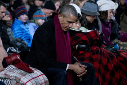 President Barack Obama bows his head in prayer during the National Christmas Tree Lighting ceremony at the Ellipse in Washington, Thursday, Dec. 3, 2015. (AP Photo/Carolyn Kaster)