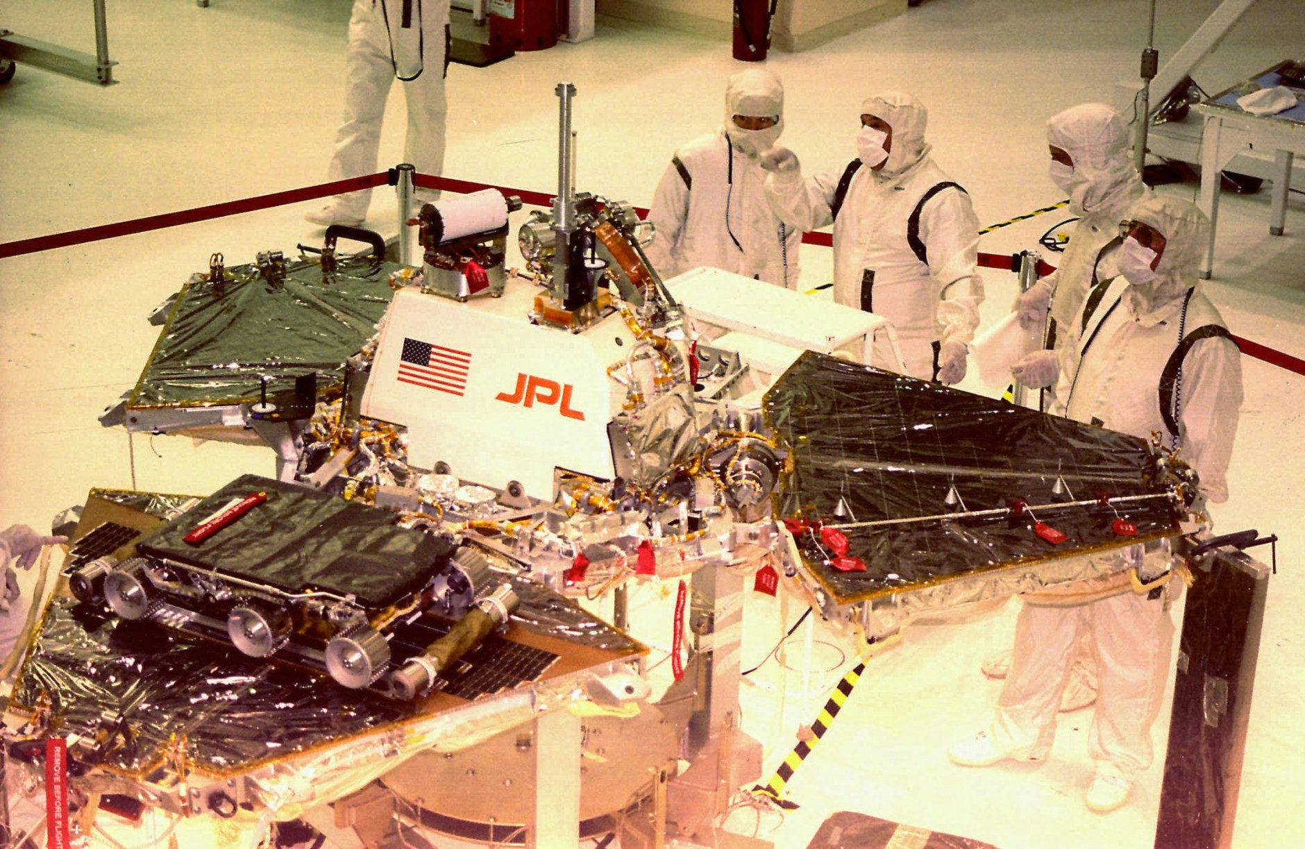 ADVANCE FOR SUNDAY, JUNE 29--FILE--Workers from NASA's Jet Propulsion Labs look over the  Mars Pathfinder Oct. 1, 1996 at Kennedy Space Center in Florida. The spacecraft will land on Mars July 4, 1997, and the rover Sojourner lower left with wheels, will explore the surface of the planet.   (AP Photo/Florida Today,Mike Brown)
