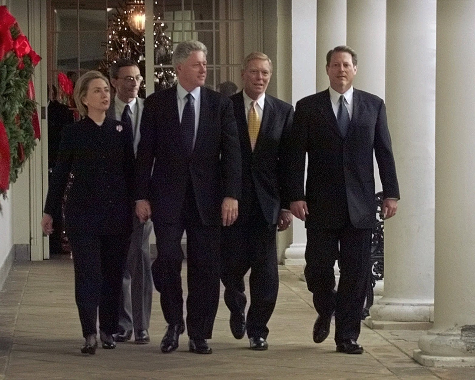 President Bill Clinton holds hands with First Lady Hillary Rodham Clinton while on the way to a rally with House Democrats following a historic vote in the House of Representatives to impeach the President. Walking with the first couple is White House Chief of Staff John Podesta, House Minority Leader Richard Gephardt and Vice President Al Gore. (AP Photo/Greg Gibson)