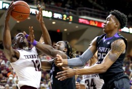 In this photo provided by Sam Craft, Texas A&amp;M's Jalen Jones (12) fights for a rebound against Kansas State's D.J. Johnson (4) and Wesley Iwundu (25) during an NCAA college basketball game on Saturday, Dec. 12, 2015, in College Station Texas. (Sam Craft via AP)