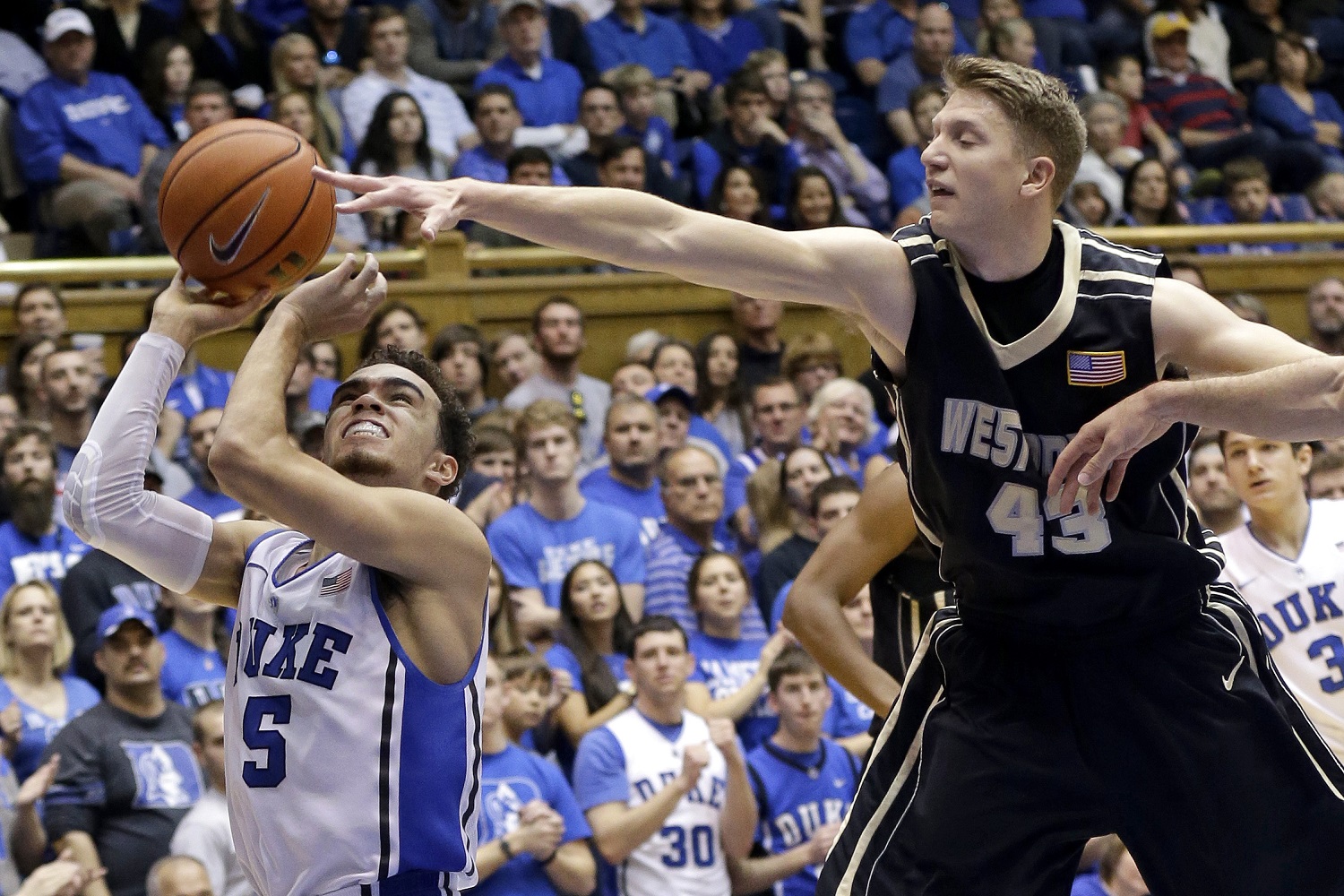 Duke's Tyus Jones (5) drives to the basket as Army's Travis Rollo (43) defends during the second half of an NCAA college basketball game in Durham, N.C., Sunday, Nov. 30, 2014. Duke won 93-73. (AP Photo/Gerry Broome)