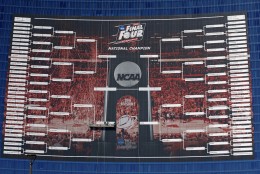 Workers complete the Final Four match ups on a 2015 NCAA Division I Mens Basketball Championship bracket that is displayed on the side of the JW Marriott, in Indianapolis, Monday, March 30, 2015. (AP Photo/Michael Conroy)