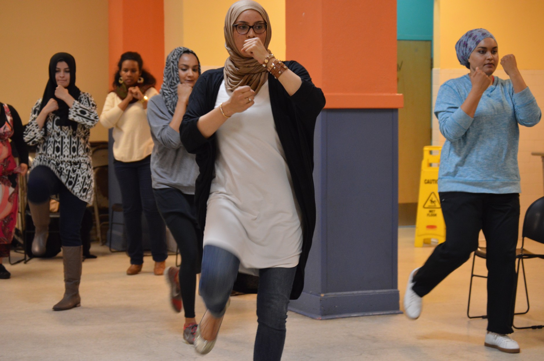 Siddiqui practices her front kick with fists out. (WTOP/Omama Altaleb)