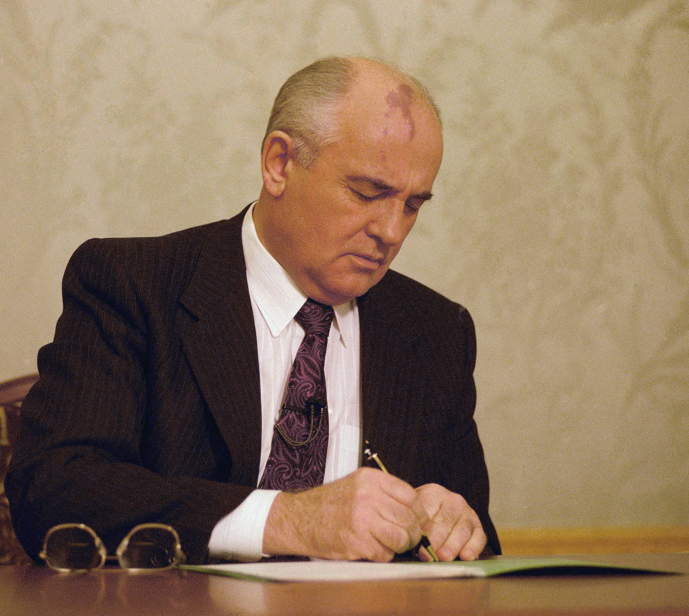 Mikhail Gorbachev, the final leader of the Soviet Union, signs the decree relinquishing control of nuclear weapons to Boris Yeltsin at the Kremlin in Moscow, Wednesday, Dec. 25, 1991. Gorbachev, whose reforms gave Soviet citizens freedom, ended the Cold War and ultimately led to the destruction of his nation. He resigned on Wednesday as president of an empire that no longer exists. (AP Photo/Liu Heung Shing)