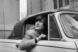 18th February 1965:  Singer, songwriter and guitarist John Lennon of The Beatles in his Triumph Herald convertible car.  (Photo by Evening Standard/Getty Images)