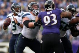 BALTIMORE, MD - DECEMBER 13: Quarterback Russell Wilson #3 of the Seattle Seahawks drops back to pass while defensive end Lawrence Guy #93 of the Baltimore Ravens defends in the third quarter at M&amp;T Bank Stadium on December 13, 2015 in Baltimore, Maryland. (Photo by Patrick Smith/Getty Images)