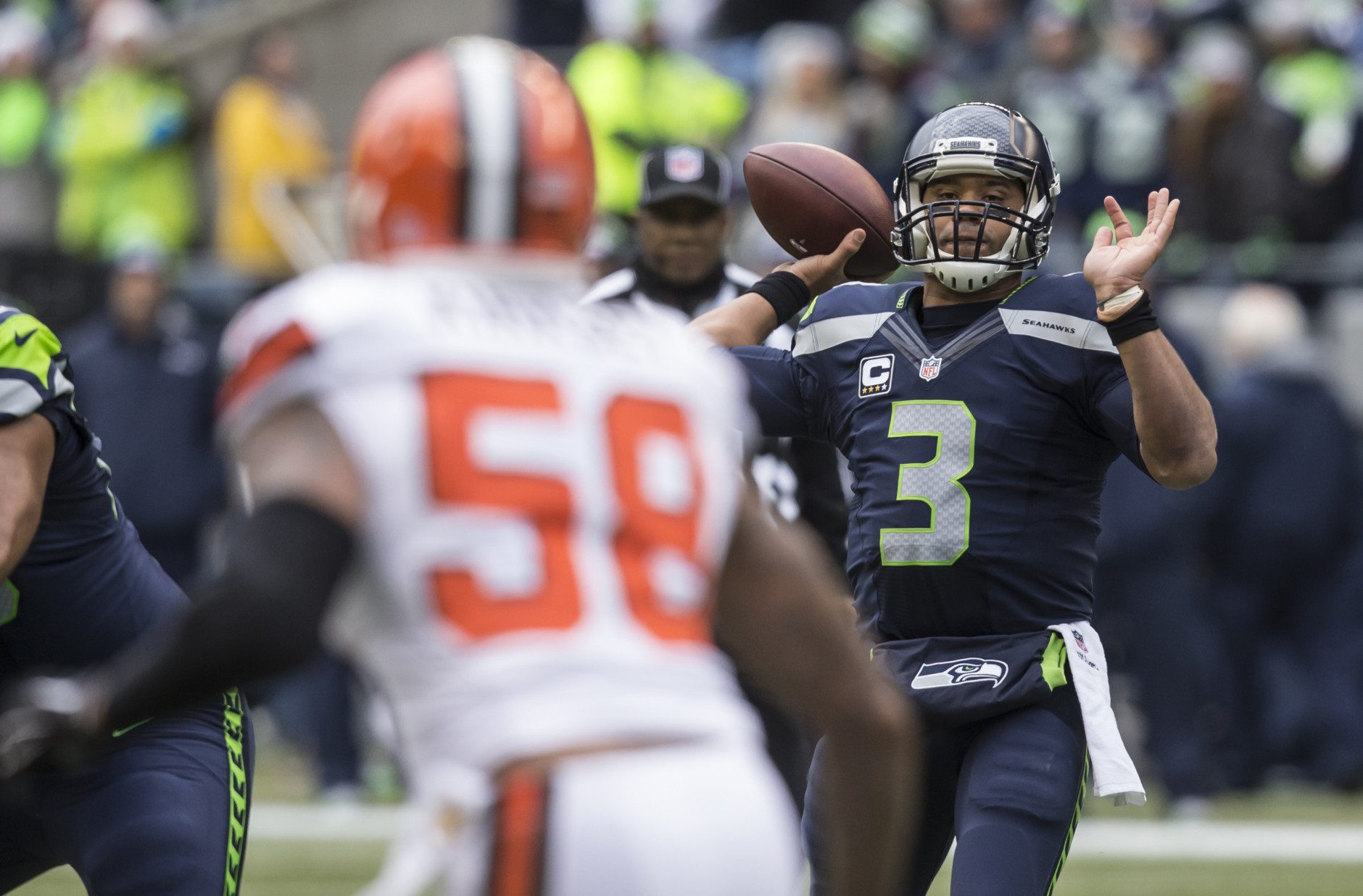 SEATTLE, WA - DECEMBER 20: Quarterback Russell Wilson #3 of the Seattle Seahawks passes the ball during the first half of a football game against the Cleveland Browns at CenturyLink Field on December 20, 2015 in Seattle, Washington. (Photo by Stephen Brashear/Getty Images)