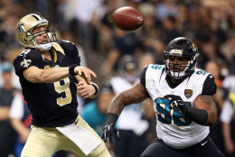 NEW ORLEANS, LA - DECEMBER 27:  Drew Brees #9 of the New Orleans Saints is pursued by Chris Smith #98 of the Jacksonville Jaguars during the second quarter of a game at the Mercedes-Benz Superdome on December 27, 2015 in New Orleans, Louisiana.  (Photo by Sean Gardner/Getty Images)