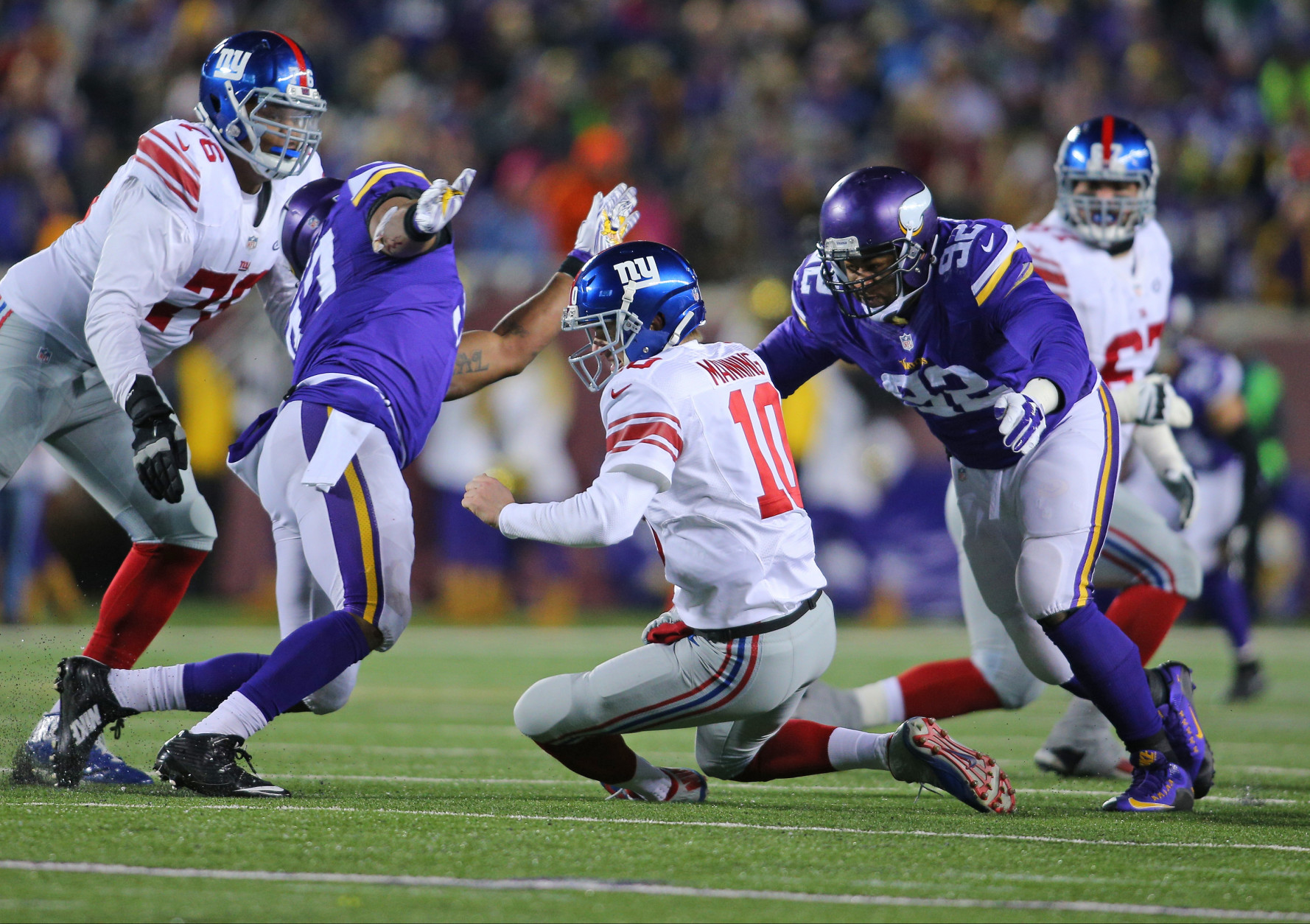 MINNEAPOLIS, MN - DECEMBER 27:  Eli Manning #10 of the New York Giants takes a dive while Everson Griffen #97 and Tom Johnson #92 of the Minnesota Vikings go for the tackle in the second quarter on December 27, 2015 at TCF Bank Stadium in Minneapolis, Minnesota. (Photo by Adam Bettcher/Getty Images)