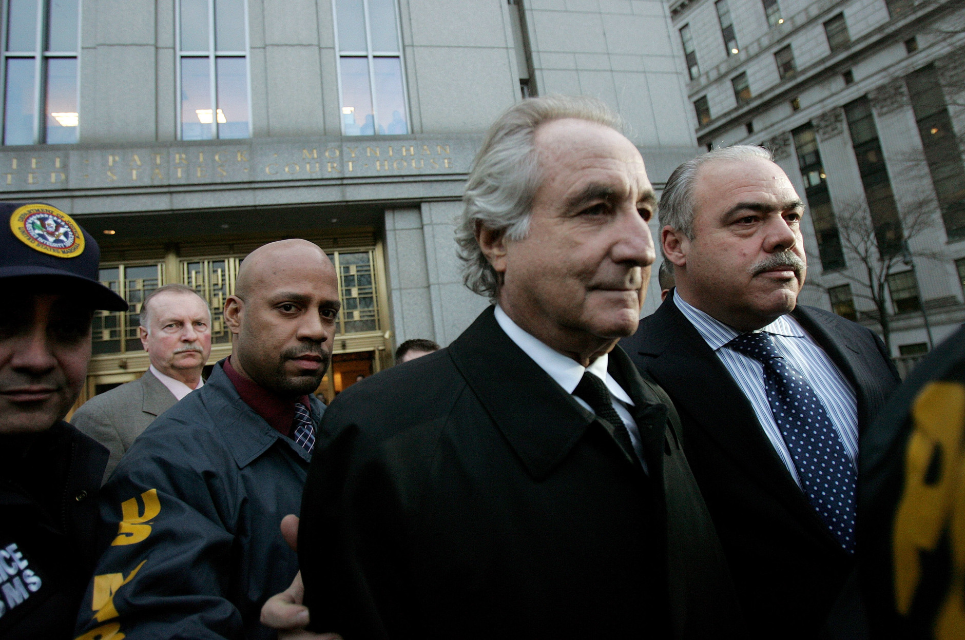 NEW YORK - JANUARY 5:  Bernard Madoff (L) walks out from Federal Court after a bail hearing in Manhattan January 5, 2009 in New York City. Madoff is accused of running a $50 billion Ponzi scheme through his investment company. Madoff is free on bail and hasn�t formally responded to the charges or entered a plea.  (Photo by Hiroko Masuike/Getty Images)