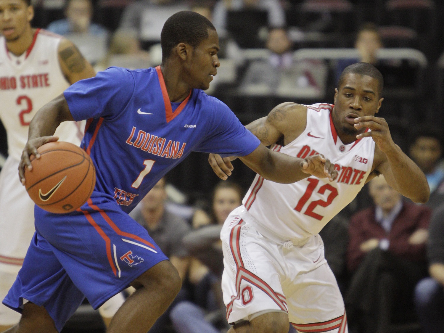 Louisiana Tech's Derric Jean (1)  tries to dribble past Ohio State's A.J. Harris (12) during the first half of an NCAA college basketball game Tuesday, Nov. 24, 2015, in Columbus, Ohio. (AP Photo/Jay LaPrete)
