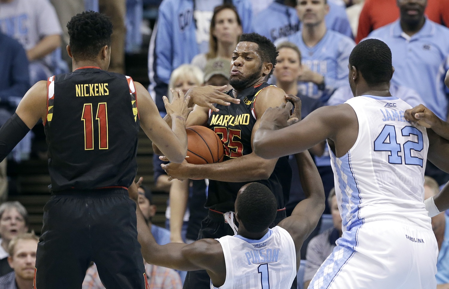 North Carolina's Theo Pinson (1) and Joel James (42) defend as Maryland's Damonte Dodd (35) and Jared Nickens (11) reach for a rebound during the first half of an NCAA college basketball game in Chapel Hill, N.C., Tuesday, Dec. 1, 2015. (AP Photo/Gerry Broome)