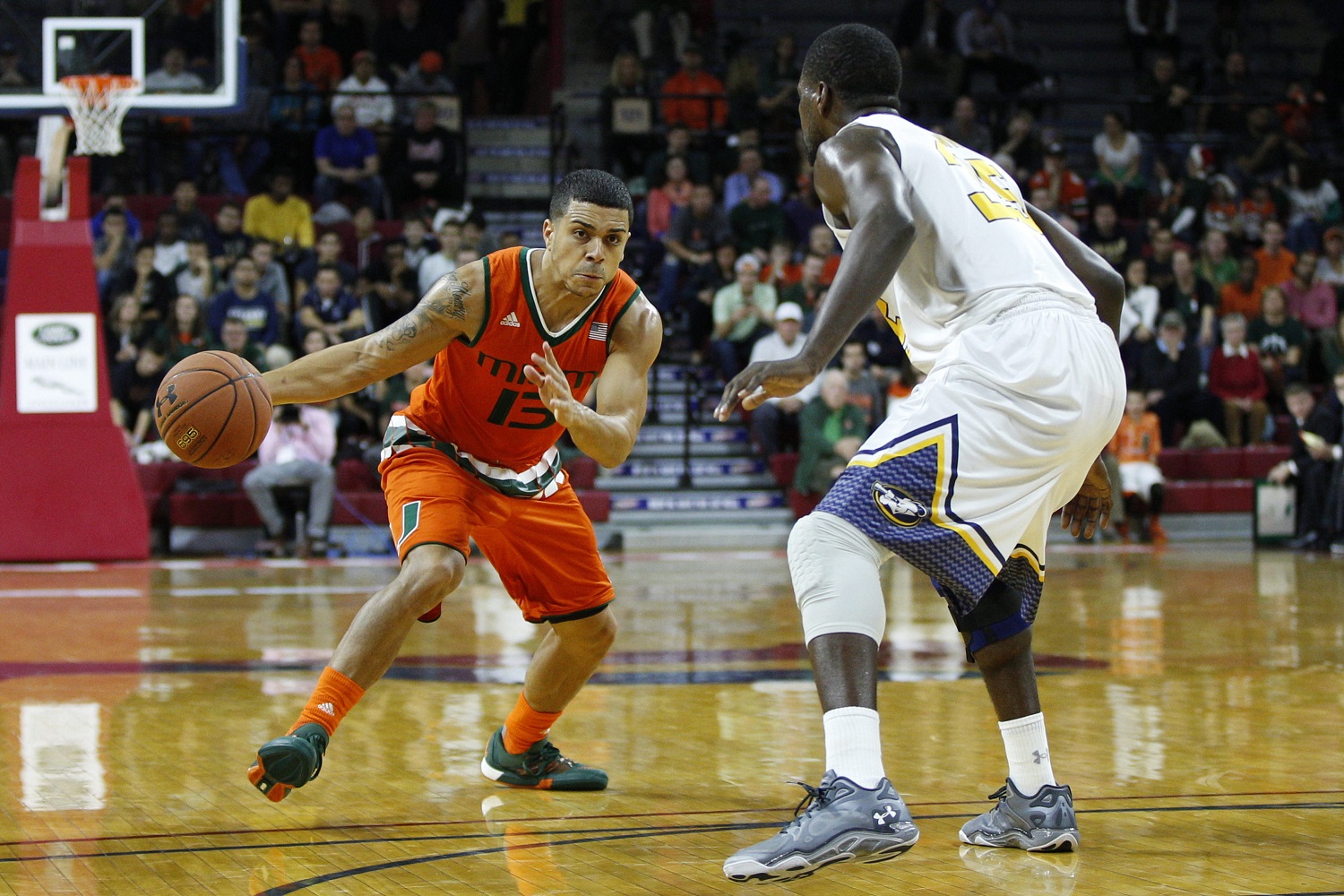 Miami's Angel Rodriguez, left, of Puerto Rico looks to make his move on La Salle's Rohan Brown, right, during the first half of an NCAA basketball game, Tuesday, Dec. 22, 2015, in Philadelphia. Miami won 95-49. (AP Photo/Chris Szagola)