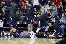 Monmouth players react on the bench to a play during the first half of an NCAA college basketball game against Rutgers, Sunday, Dec. 20, 2015, in Piscataway, N.J.  (AP Photo/Mel Evans)