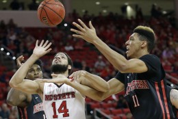 North Carolina State's Caleb Martin (14) and Northeastern's Jeremy Miller (11) reach for a rebound during the first half of an NCAA college basketball game in Raleigh, N.C., Tuesday, Dec. 29, 2015. (AP Photo/Gerry Broome)